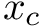 $ x_c $